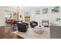 Bright, airy living room and dining room with hardwood floors and modern lighting at 1511 S Pennsylvania St, Denver, CO 80210