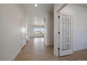 Bright entryway with wood-look flooring and a view into the living area at 11741 Magnolia St, Thornton, CO 80233