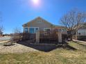 Rear exterior showcasing a wooden deck with brick columns, ideal for outdoor entertaining at 22967 E Mineral Pl, Aurora, CO 80016