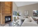 Cozy living room with a brick fireplace, large windows, and ample seating at 2685 S Dayton Way # 145, Denver, CO 80231