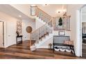 Elegant staircase with wrought iron railing and wooden steps at 27319 E Nova Cir, Aurora, CO 80016