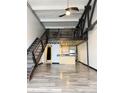 Open living space with metal stairs, hardwood floors, modern kitchen, and upstairs loft area at 1111 Osage St # 7, Denver, CO 80204