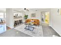 Stylish living room with modern furnishings and an open layout connecting to the kitchen at 5735 W Atlantic Pl # 101, Lakewood, CO 80227