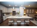 Bright kitchen featuring white cabinetry, a large island with seating, and stainless steel appliances at 359 Courtfield Way, Castle Pines, CO 80108