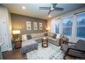 Comfortable living room featuring an oversized couch, decorative wall art, and lots of natural light at 359 Courtfield Way, Castle Pines, CO 80108