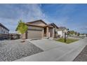 Lovely single-story home with two-car garage, landscaped with stone and a tree-lined yard at 21436 E Stanford Ave, Aurora, CO 80015