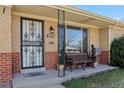 Inviting front porch with a decorative security door and a comfortable bench for relaxing at 2540 W Gunnison Dr, Denver, CO 80219