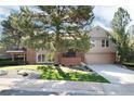 A two-story home with a lush lawn, mature trees and a two car garage at 8004 S Oneida Ct, Centennial, CO 80112
