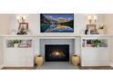 Cozy fireplace with detailed mantel, blue tile surround, and built-in cabinets at 8004 S Oneida Ct, Centennial, CO 80112