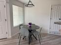 Cozy dining area with modern table and chairs, illuminated by a stylish pendant light at 13781 E Lehigh Ave # E, Aurora, CO 80014
