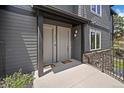 Inviting entryway featuring modern gray siding and convenient unit numbers at 31191 Black Eagle Dr # 304, Evergreen, CO 80439