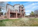 The backyard showcases a multi-level deck and brick pillars, perfect for outdoor entertaining at 22090 E Arbor Dr, Aurora, CO 80016