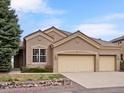 Charming single-story home boasts a three-car garage and beautifully landscaped front yard at 16631 Red Cliff Cir, Morrison, CO 80465