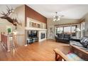 Spacious living room featuring vaulted ceilings, a fireplace, and large windows for natural light at 21863 E Oxford Pl, Aurora, CO 80018