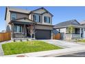 Two-story house with gray siding, stone accents, and a two-car garage at 9876 Ceylon Ct, Commerce City, CO 80022