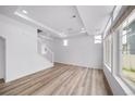 Spacious living room with light hardwood flooring, recessed lighting, and bright natural light at 1182 Sugarloaf Ln, Erie, CO 80516