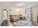 Inviting living room featuring neutral walls, a plush sofa set, and bright natural light at 2831 W Irvington Pl, Denver, CO 80219