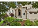 Charming home entrance with a stone-accented archway and landscaped garden at 4678 Springmeadow Ln, Castle Rock, CO 80109
