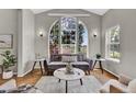 Bright living room featuring a large arched window and hardwood floors at 4678 Springmeadow Ln, Castle Rock, CO 80109
