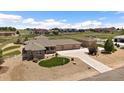 Expansive property featuring a sprawling lawn, white picket fence, and a home with an attached three-car garage at 12590 Valentia St, Thornton, CO 80602