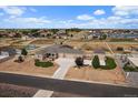 Beautiful aerial view showcasing large lot, white fencing, outbuildings, and surrounding neighborhood at 12590 Valentia St, Thornton, CO 80602