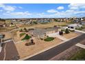A high angle shot capturing the residence's large lot, white fences, and outbuildings at 12590 Valentia St, Thornton, CO 80602