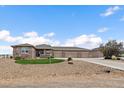 Charming home featuring a stone facade, three-car garage, and well-maintained landscaping at 12590 Valentia St, Thornton, CO 80602