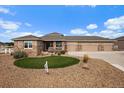 Charming ranch home featuring a three-car garage, manicured landscaping, and stone accents at 12590 Valentia St, Thornton, CO 80602