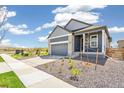 Charming single-Gathering home showcasing a two-car garage and xeriscaped front yard at 9265 Cathay Ct, Commerce City, CO 80022