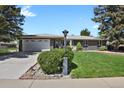 A charming single-story home with a well-manicured lawn and an attached two-car garage at 2301 Dunbar Ct, Longmont, CO 80501