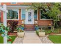 Close up of a cozy front porch with flower pots and a decorative display at 1521 Pontiac St, Denver, CO 80220