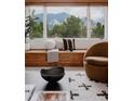 Bright living room featuring a comfortable reading nook with mountain views at 1312 Sandstone Ct, Boulder, CO 80305
