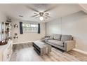 Cozy living room with neutral gray walls, wood-look floors, and modern furnishings at 1612 Cottonwood Dr # 2W, Louisville, CO 80027