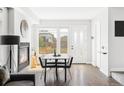 Bright dining room featuring a modern fireplace, stylish table set, and hardwood floors at 1457 Yates St, Denver, CO 80204
