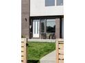 Inviting front entrance with modern brickwork, lush lawn, and stylish outdoor seating area at 1457 Yates St, Denver, CO 80204