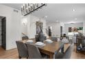 Dining room featuring a stylish chandelier over a wood table with seating for six, bathed in natural light at 535 Josephine St, Denver, CO 80206