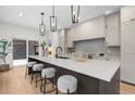 Modern kitchen with sleek white countertops, pendant lighting, and seating at the large kitchen island at 535 Josephine St, Denver, CO 80206
