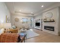 Bright living room with stone fireplace, hardwood floors, built in shelving and a walk out to the patio at 6747 W Jewell Pl, Lakewood, CO 80227