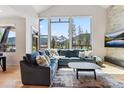Bright living room with mountain view, large windows, comfortable seating, and hardwood floors at 427 Whispering Pines Cir, Breckenridge, CO 80424