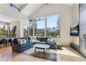 Open living area with ample light and scenic mountain views through large windows at 427 Whispering Pines Cir, Breckenridge, CO 80424