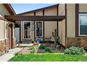 Inviting front porch features a cozy bench, desert plants, and stylish decor, enhancing its curb appeal at 214 Poppy St, Golden, CO 80401