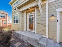 Close up of front door including porch with decorative wooden accents and steps at 3812 Red Deer Trl # D, Broomfield, CO 80020