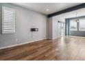 Open concept living room with wood floors, plantation shutters, and modern light fixtures at 3812 Red Deer Trl # D, Broomfield, CO 80020