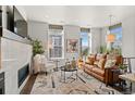 Bright living room featuring a fireplace, comfortable seating, and large windows with natural light at 4625 W 50Th Ave # 110, Denver, CO 80212
