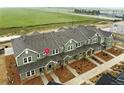 Expansive aerial view of townhouses with landscaped surroundings, offering a serene community setting at 17125 W 91St Ln, Arvada, CO 80007