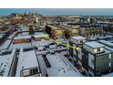 An aerial view of a modern home showcases its urban location near the city skyline at 1933 Grove St, Denver, CO 80204