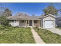 Single story home with attached one-car garage and walkway leading to the front door at 3353 S Glencoe St, Denver, CO 80222