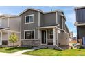 Charming two-story home with gray siding, stone accents, and a well-manicured lawn at 1075 Spartan Ave, Berthoud, CO 80513