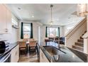 Modern kitchen with stainless steel appliances, a breakfast bar, and an open floor plan at 1075 Spartan Ave, Berthoud, CO 80513