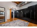 Modern entryway with black wardrobe storage and wood accents at 2955 Inca St # 2L, Denver, CO 80202